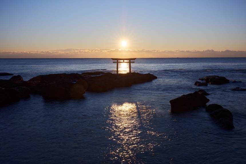 神磯の鳥居の後ろから昇る朝日と光の筋　露光時間１秒